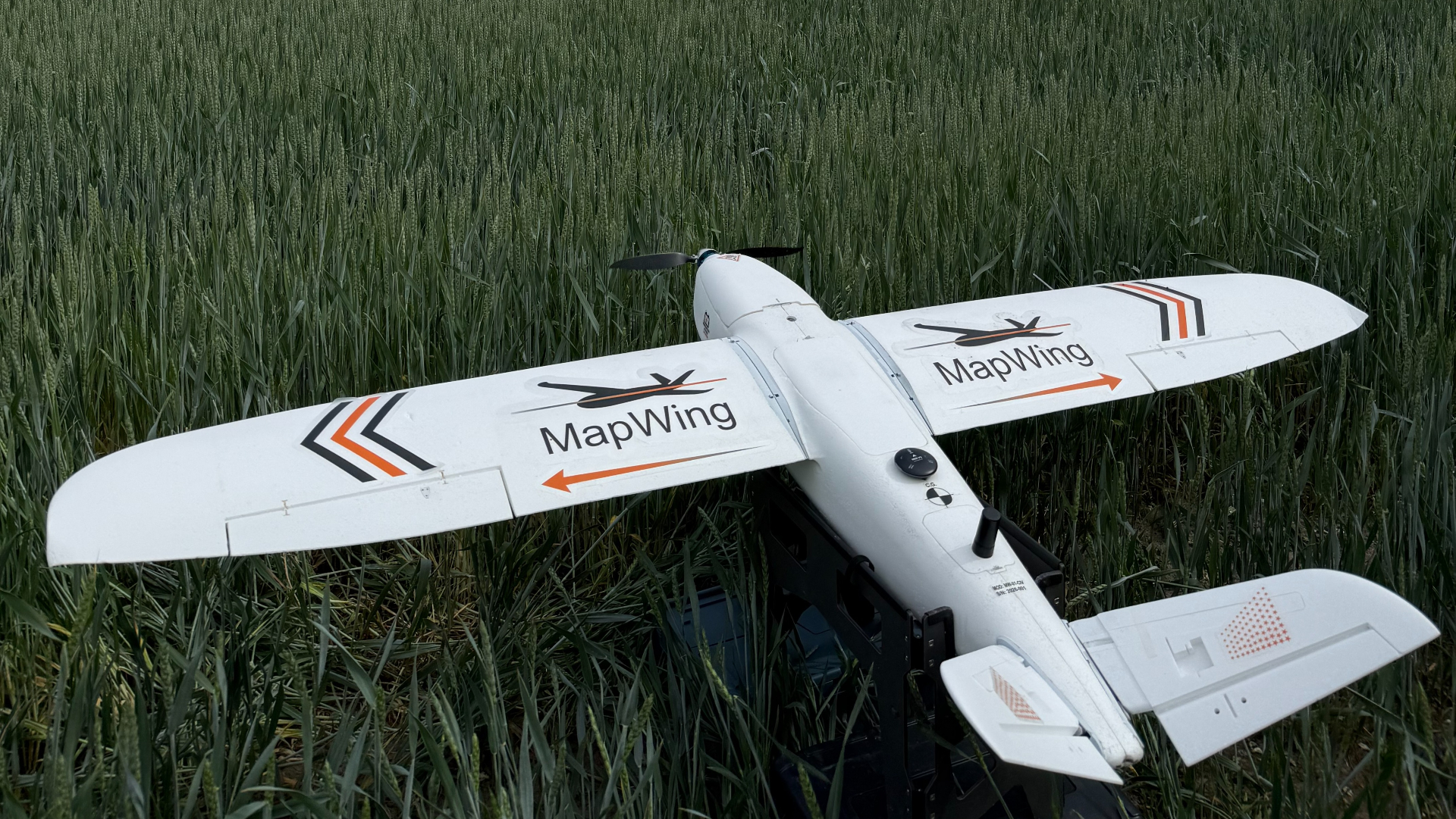 MapWing UAV deployed in a wheat field under overcast sky